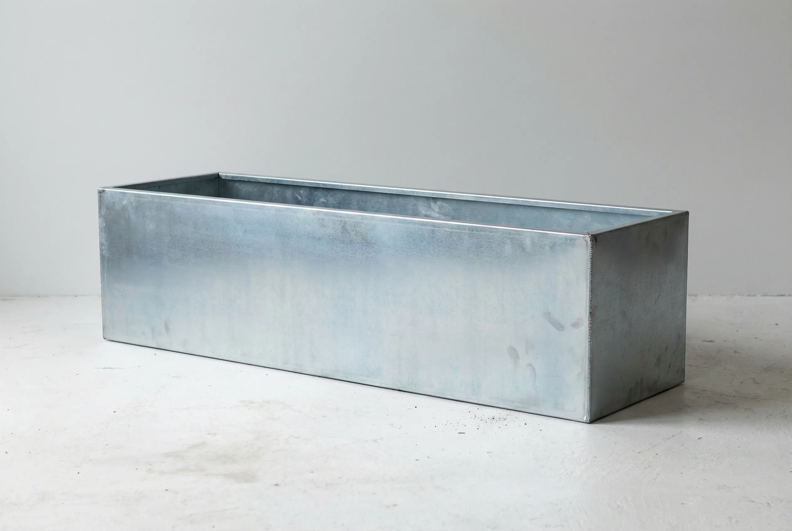 Raw galvanized steel planter finish — silver-zinc industrial aesthetic